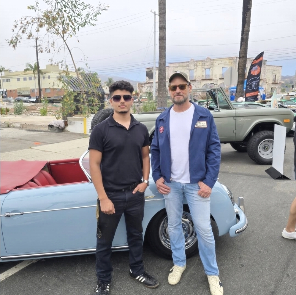 Morrissey Rodriguez with a client at a car meet